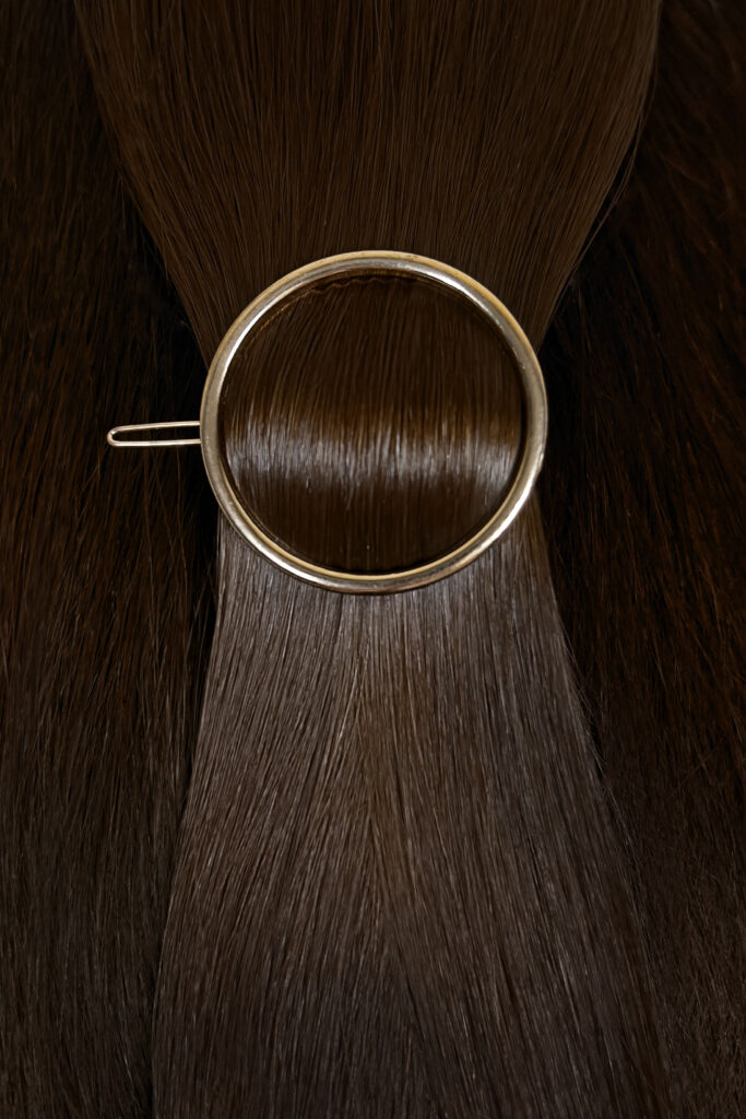 Luxurious dark brown hair on a soft surface, showing silky texture and smoothness